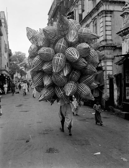 Cushing: Man Carrying Baskets (1930)